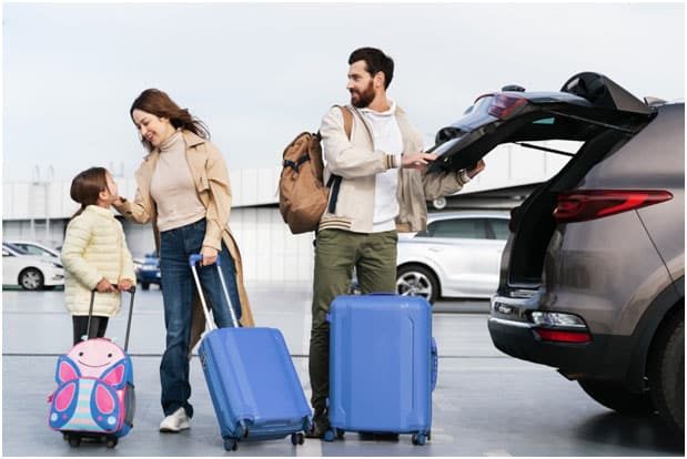Tips to Maintaining Spinal Health During Holiday Trips - Family with luggage with man closing trunk of car